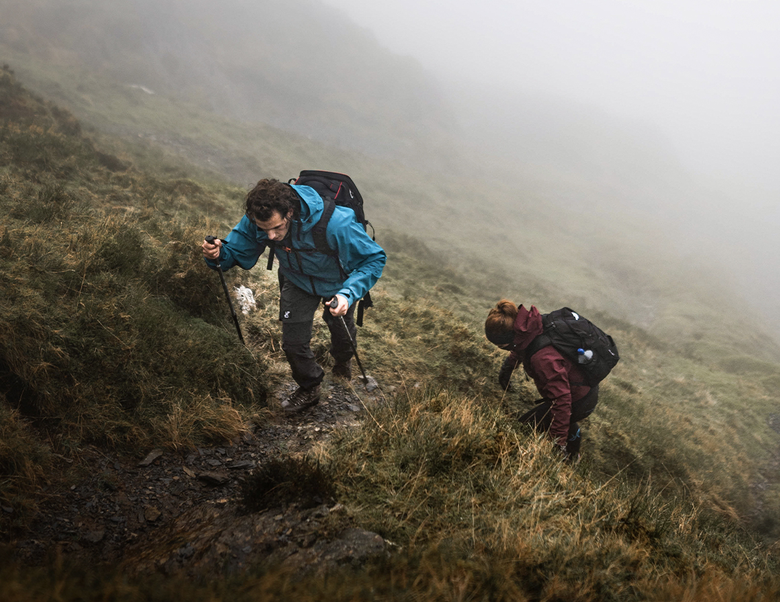 couple on hike in rainy weather cyclone rescue jacket blue and red.jpg